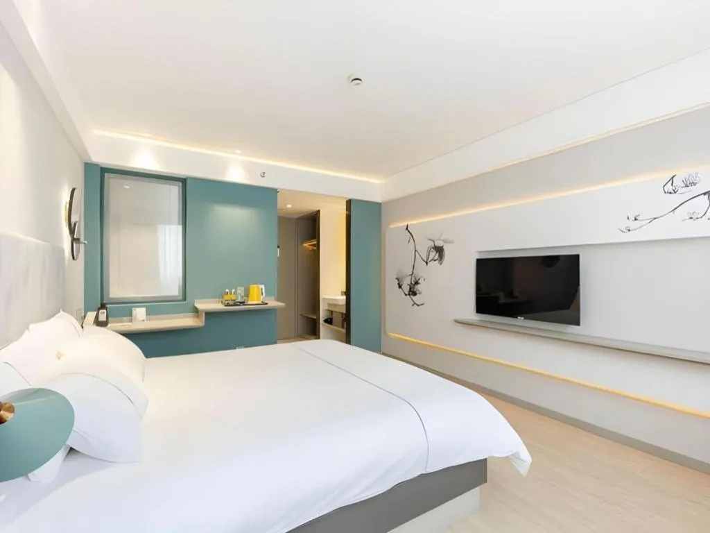 Bed in Magnotel Hotel Shanghai Jinjiang Park Branch