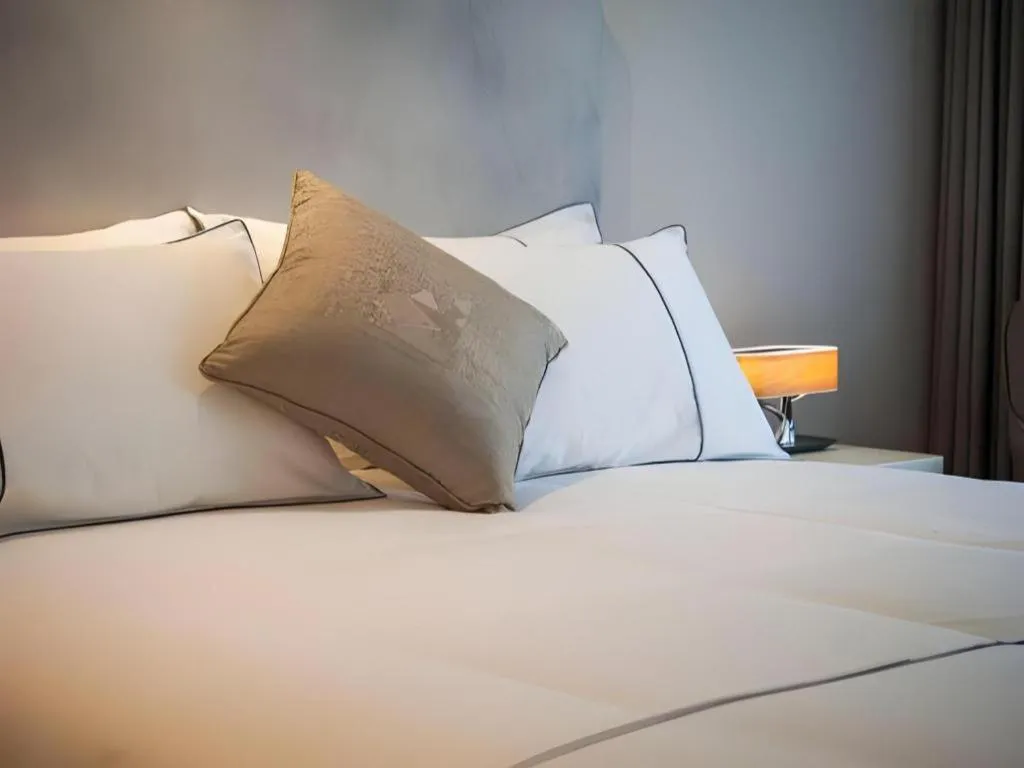 Bed in Magnotel Hotel Shanghai Jinjiang Park Branch