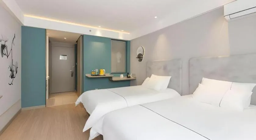 Bed in Magnotel Hotel Shanghai Jinjiang Park Branch