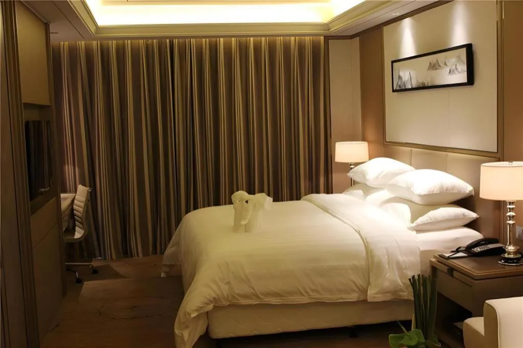 Bed in New Century Grand Hotel Hangzhou Zheshang