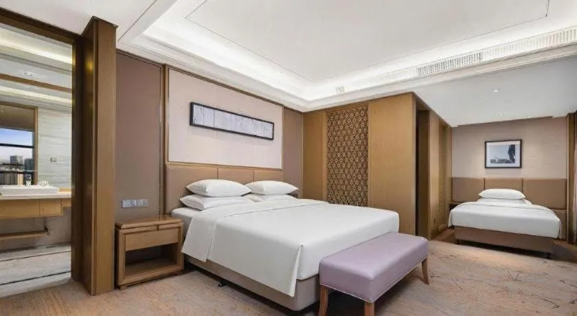 Bed in New Century Grand Hotel Hangzhou Zheshang
