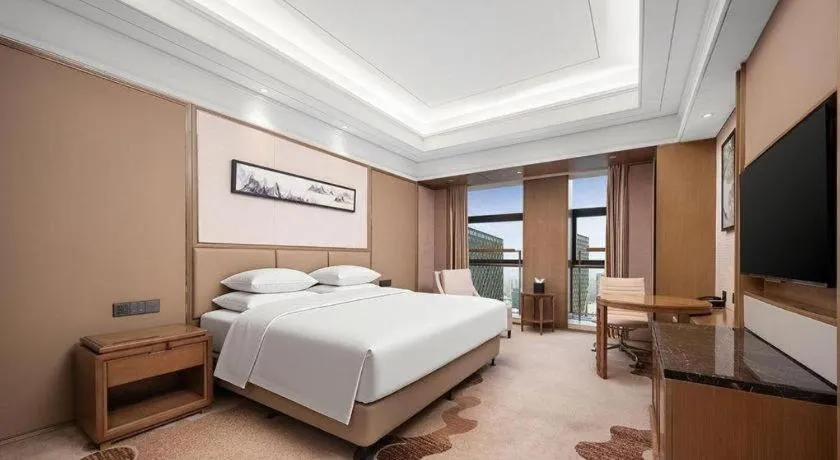 Bed in New Century Grand Hotel Hangzhou Zheshang
