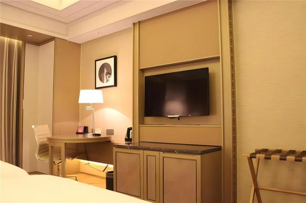 Bed in New Century Grand Hotel Hangzhou Zheshang