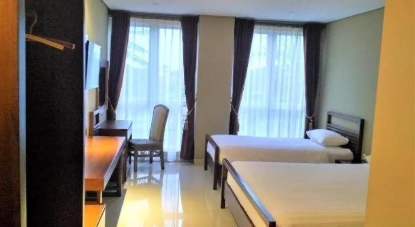 Bed in Hotel Adilla Syariah Ambarukmo