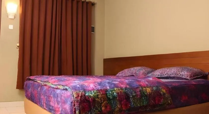 Bed in Hotel Adilla Syariah Ambarukmo