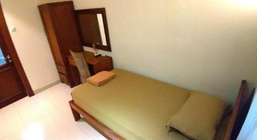 Bed in Hotel Adilla Syariah Ambarukmo