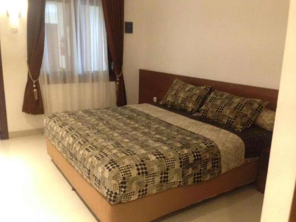 Bed in Hotel Adilla Syariah Ambarukmo