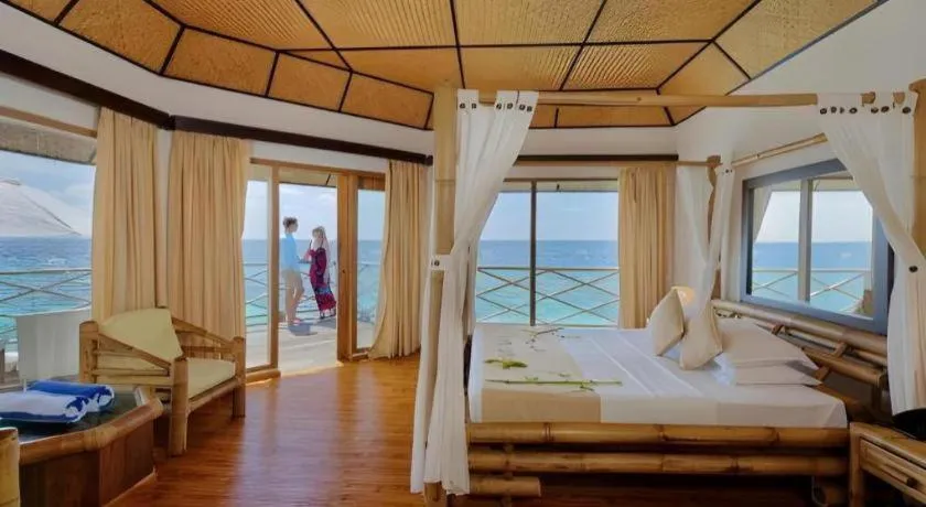Bed in Angaga Island Resort and Spa