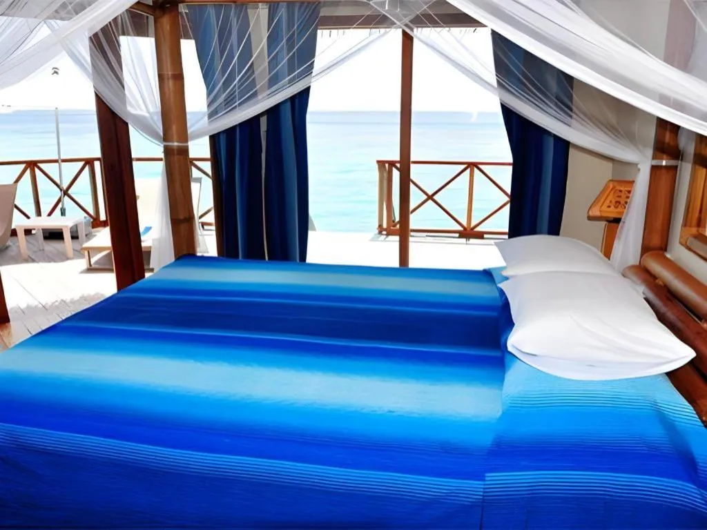 Bed in Angaga Island Resort and Spa