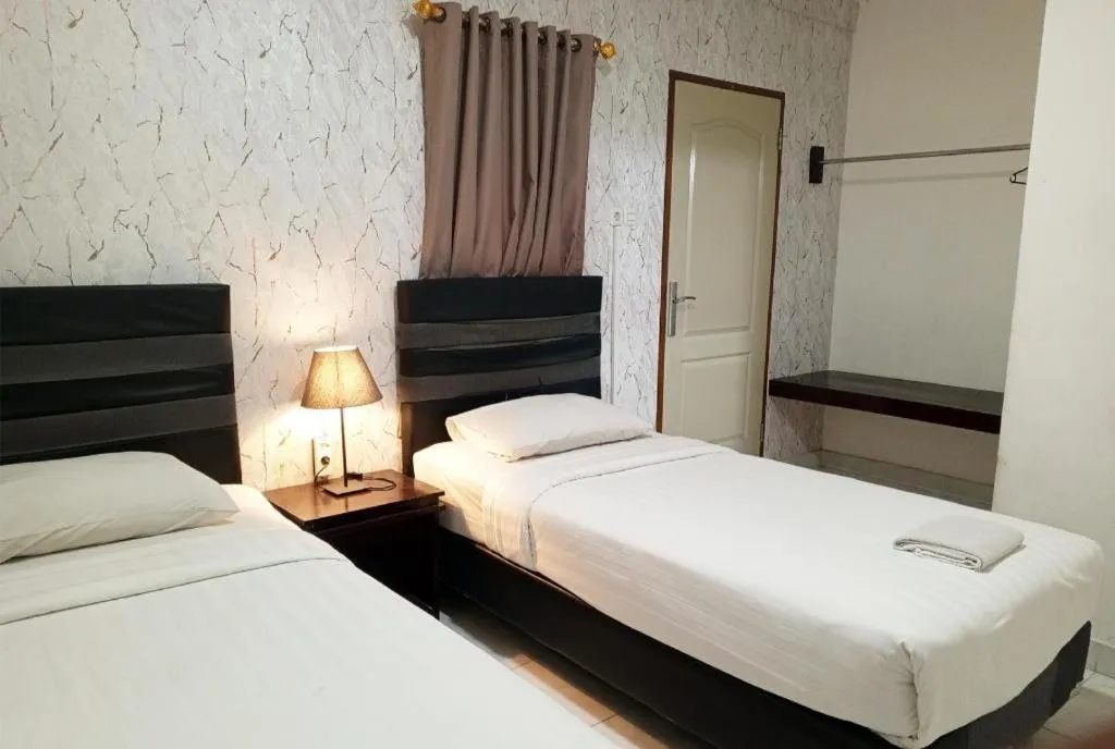 Bed in The Garden Hotel