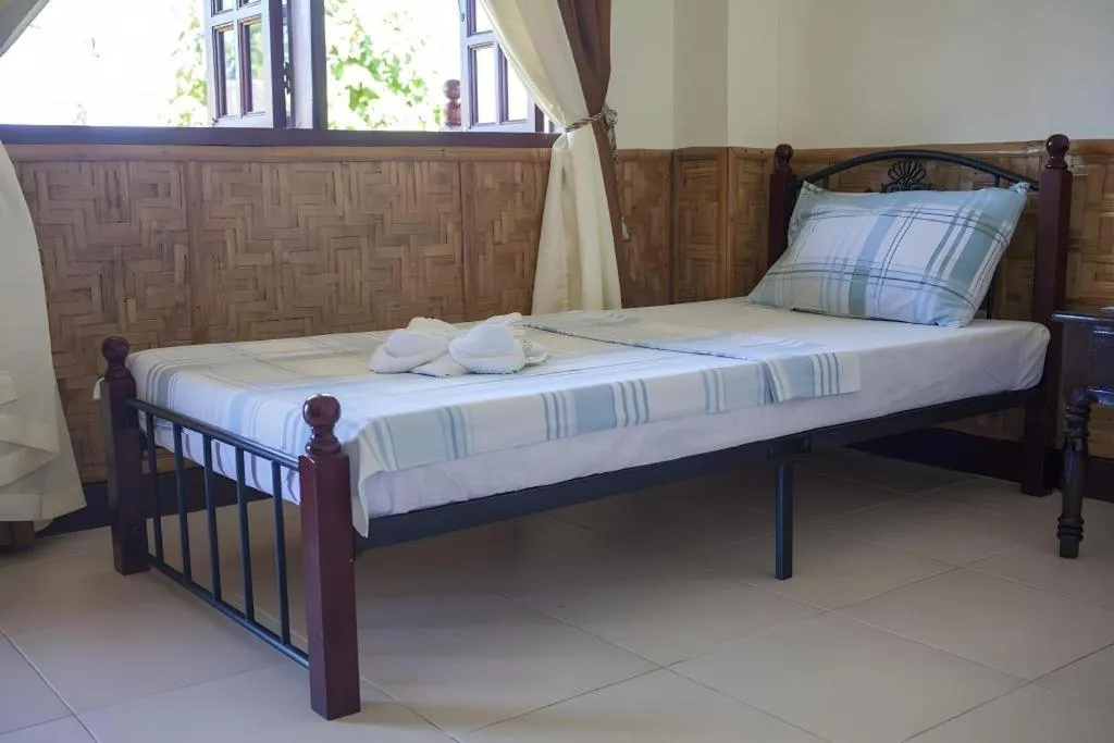 Bed in Coucou Bar Hotel and Restaurant