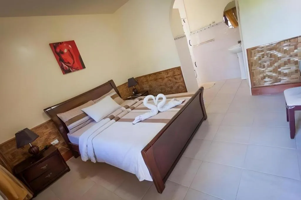 Bed in Coucou Bar Hotel and Restaurant