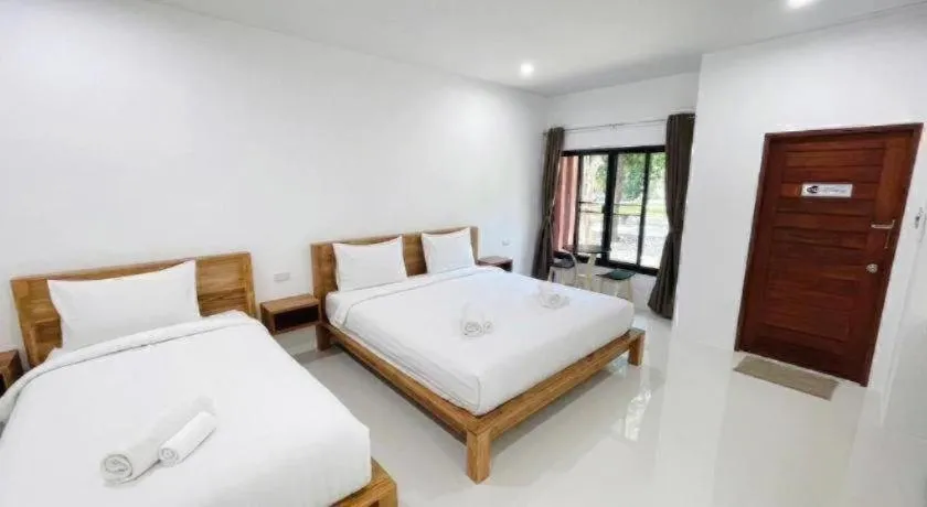 Bed in Baan Klang Suan Resort