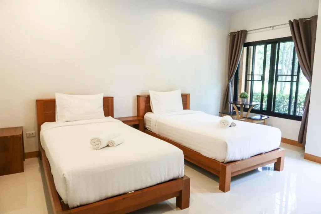 Bed in Baan Klang Suan Resort