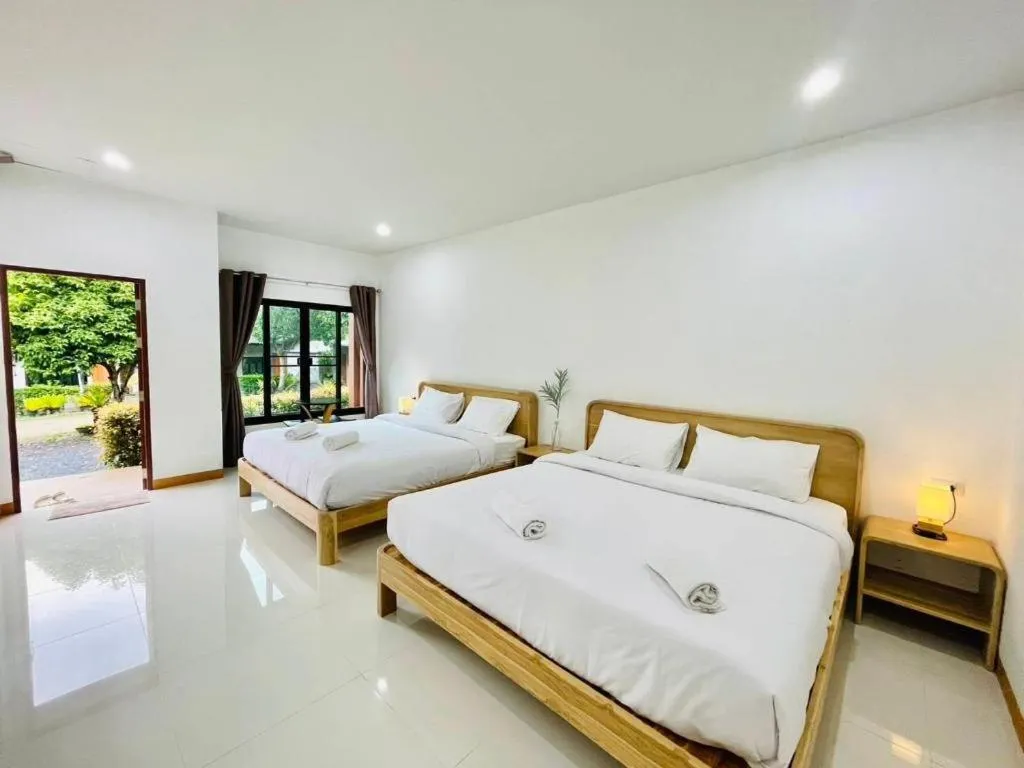 Bed in Baan Klang Suan Resort