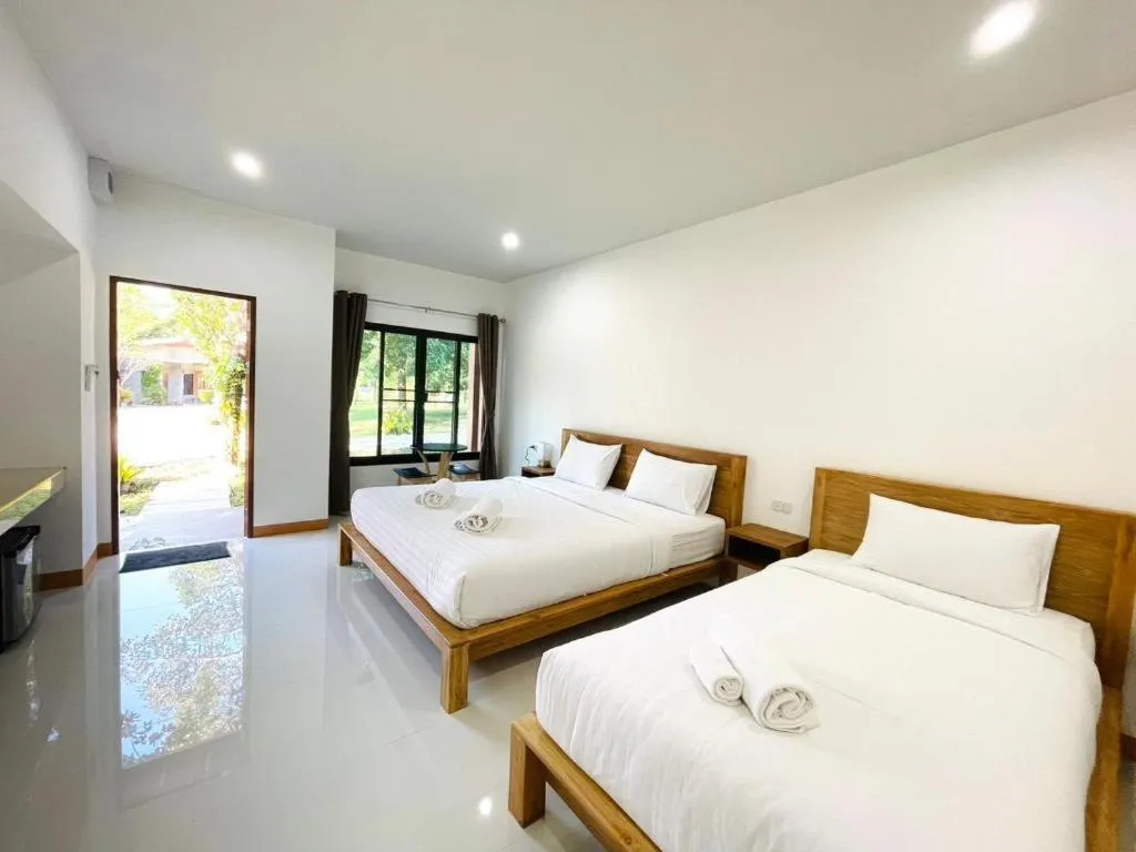 Bed in Baan Klang Suan Resort
