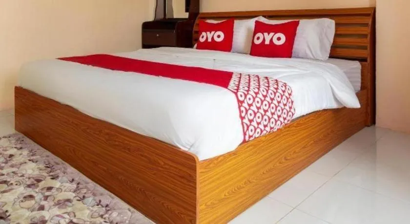 Bed in OYO 75356 Thipsiri Lodge