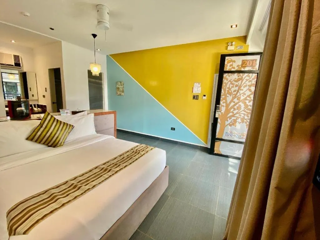 Bed in White Breeze Palawan Boutique Hotel