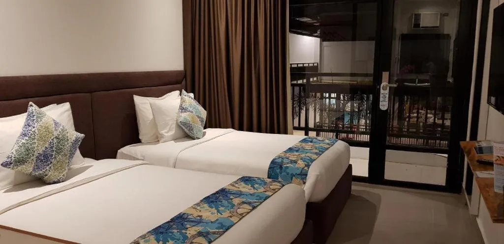 Bed in White Breeze Palawan Boutique Hotel