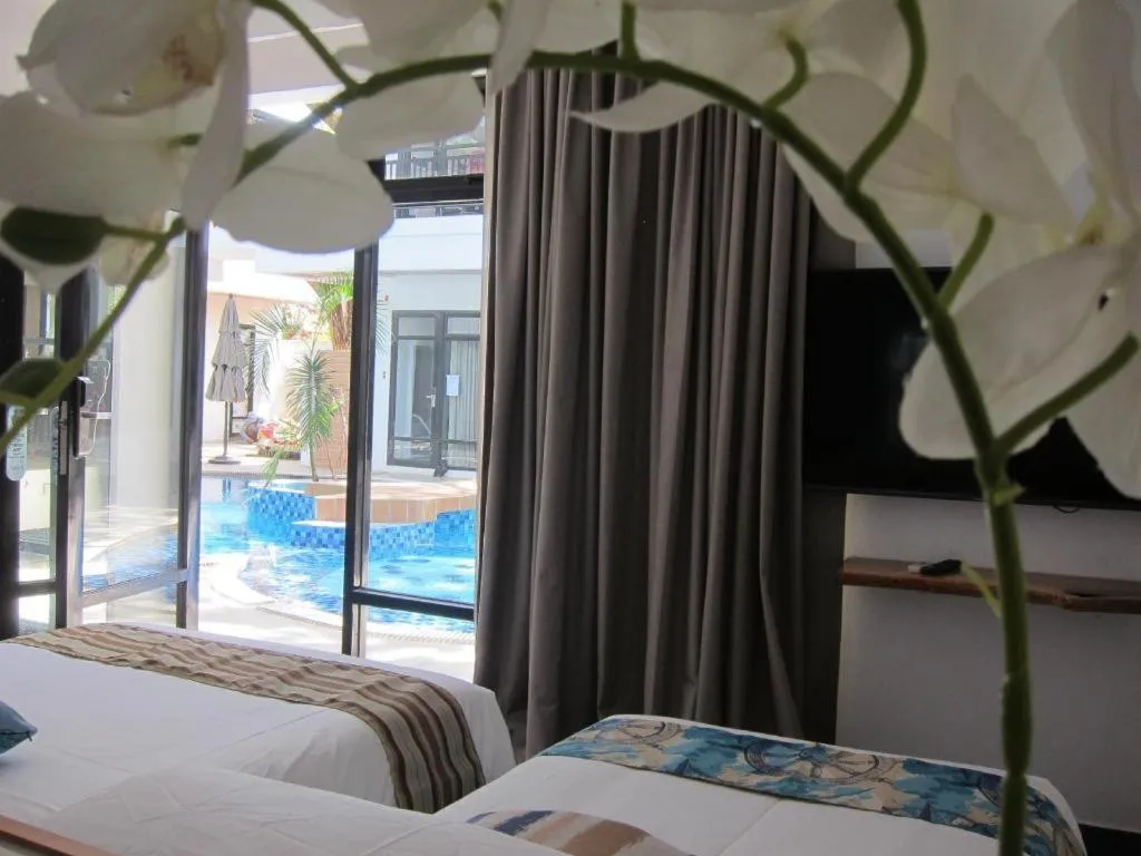 Bed in White Breeze Palawan Boutique Hotel