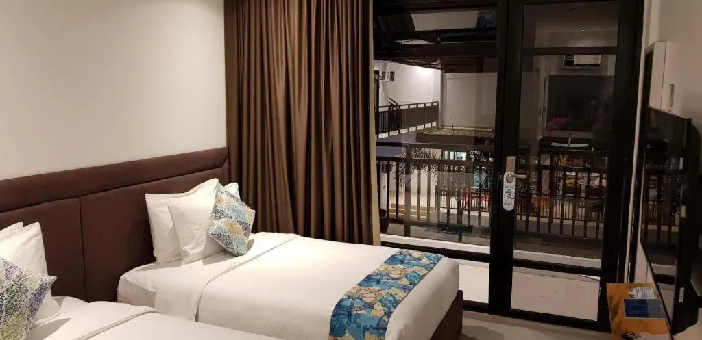 Bed in White Breeze Palawan Boutique Hotel