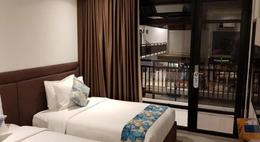 Bed in White Breeze Palawan Boutique Hotel