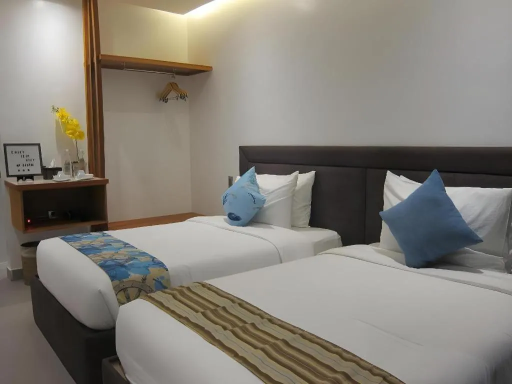 Bed in White Breeze Palawan Boutique Hotel