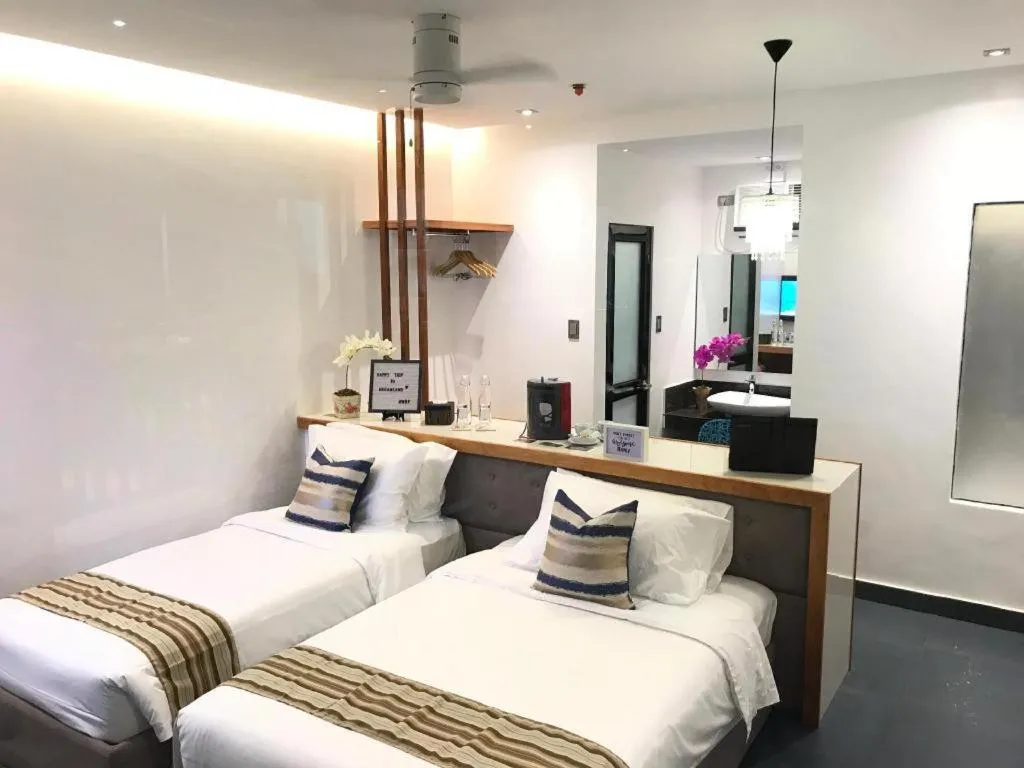 Bed in White Breeze Palawan Boutique Hotel