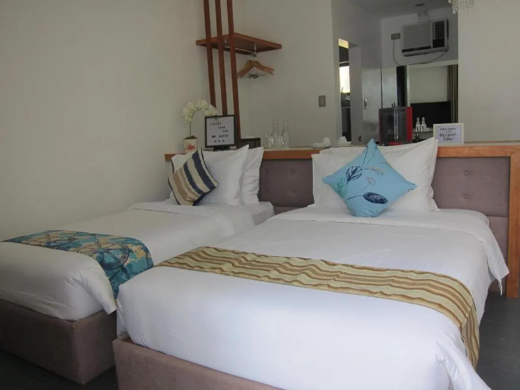Bed in White Breeze Palawan Boutique Hotel