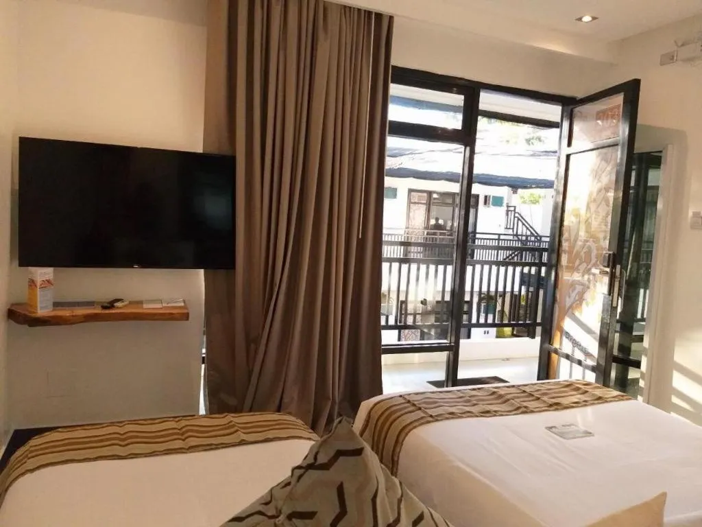 Bed in White Breeze Palawan Boutique Hotel