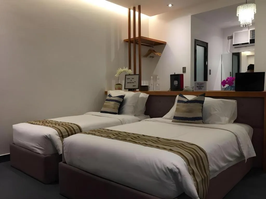 Bed in White Breeze Palawan Boutique Hotel