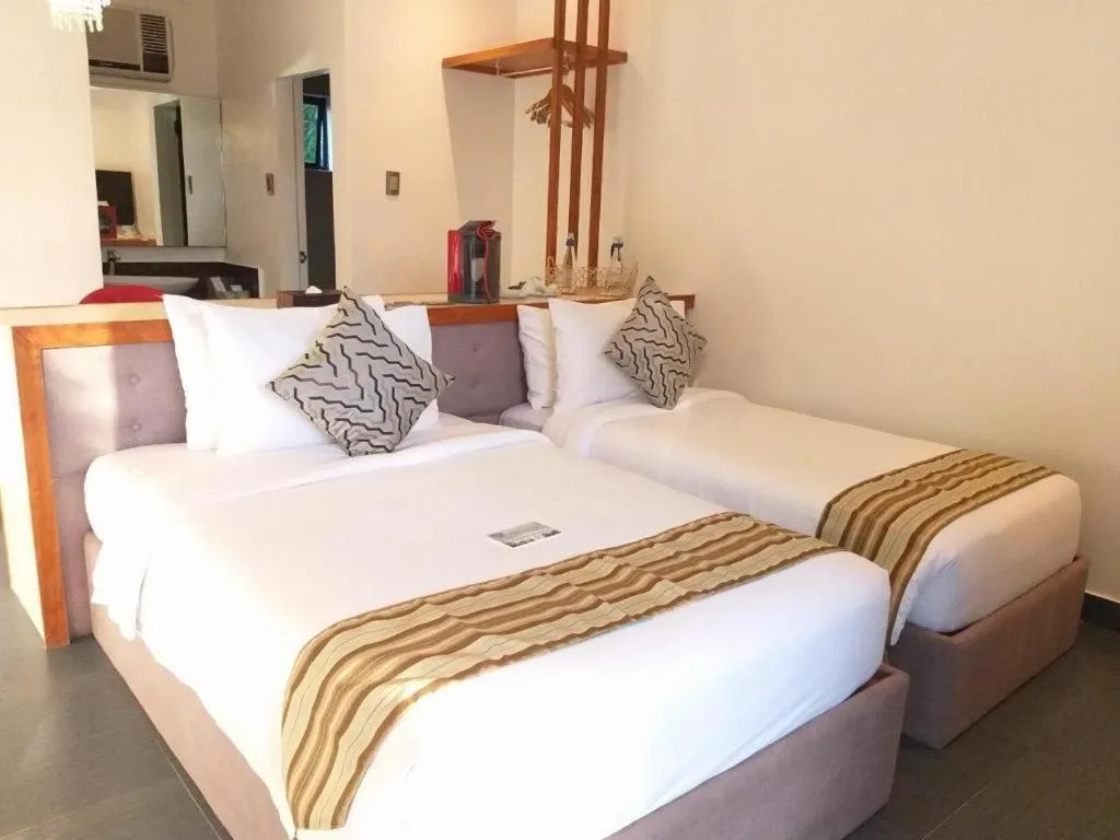 Bed in White Breeze Palawan Boutique Hotel