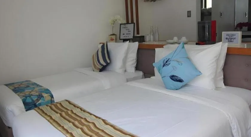 Bed in White Breeze Palawan Boutique Hotel