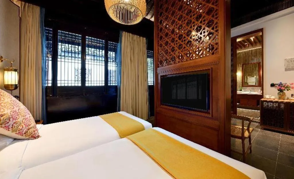 Bed in Blossom Hill Inn Suzhou Tanhuafu