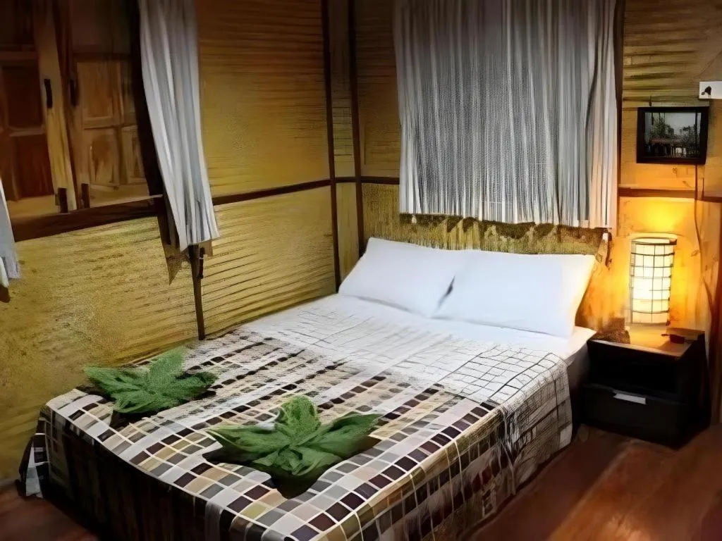 Bed in Green Cottage Beach Resort