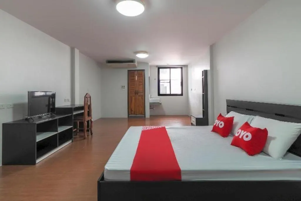 Bed in OYO 935 The Palm Apartment