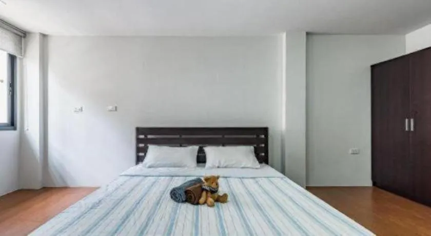 Bed in OYO 935 The Palm Apartment