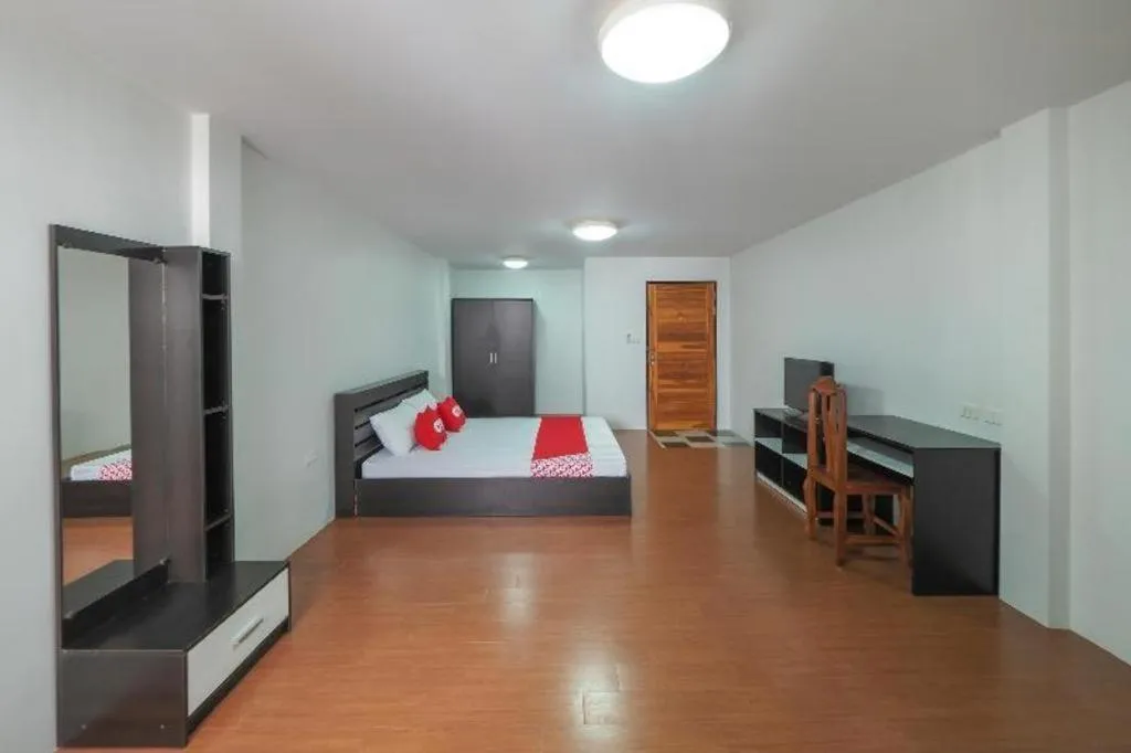 Bed in OYO 935 The Palm Apartment