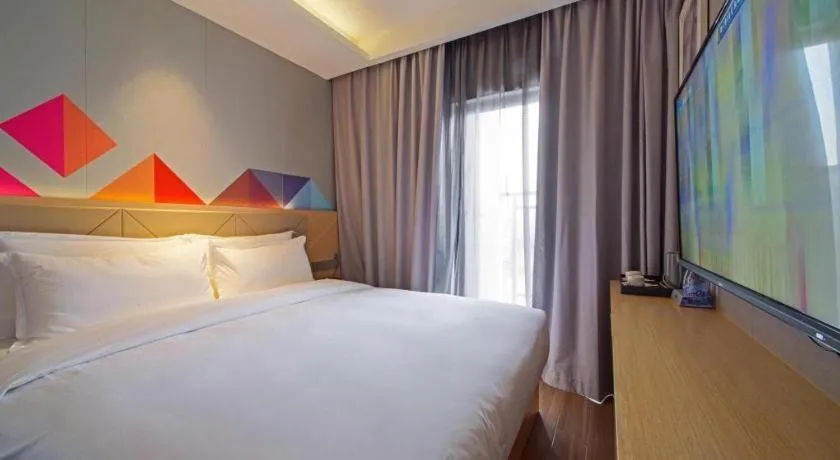 Bed in Borrman Hotel Zhaoqing Sihui Tianguangxu Jade City