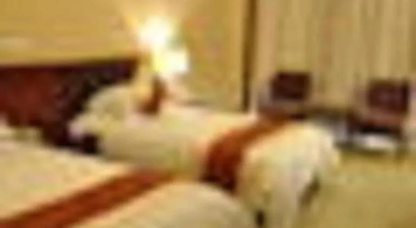 Bed in New Century Hotel Ninghai