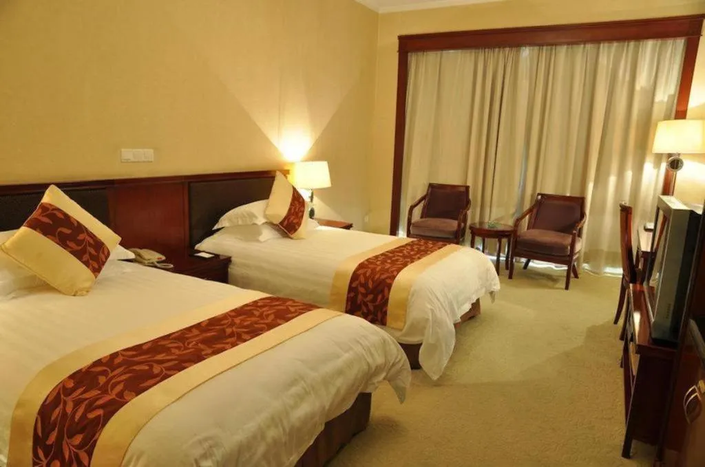 Bed in New Century Hotel Ninghai