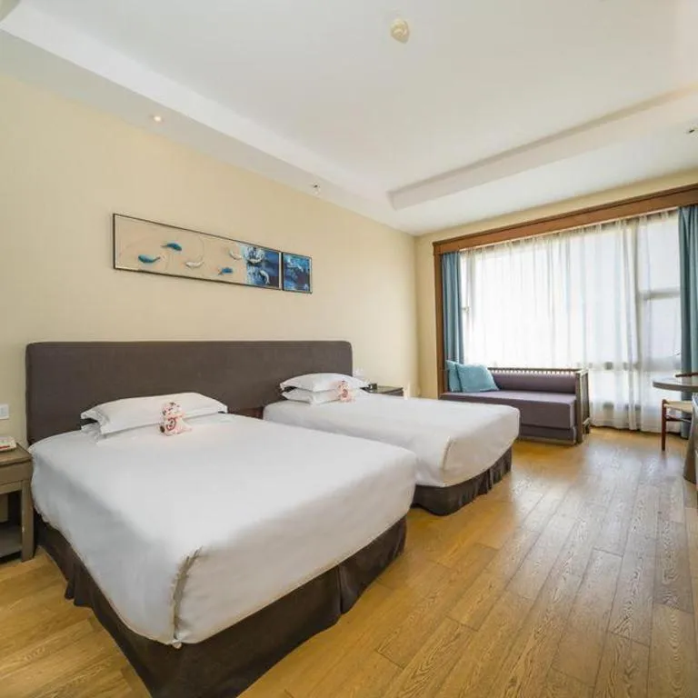 Bed in New Century Hotel Ninghai
