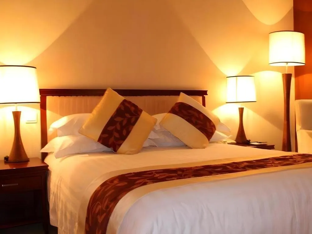 Bed in New Century Hotel Ninghai