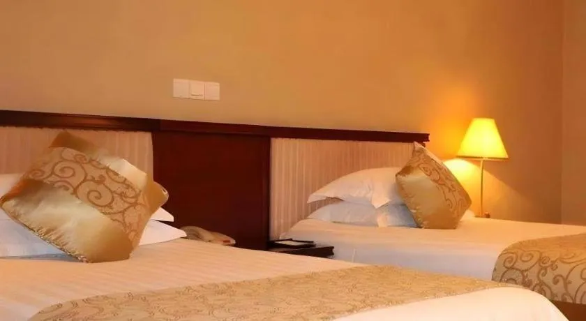 Bed in New Century Hotel Ninghai