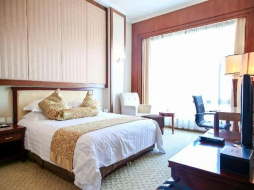 Bed in New Century Hotel Ninghai