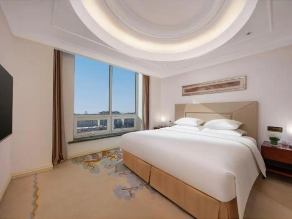 Bed in New Century Grand Changchun Hotel