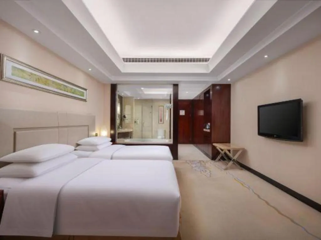 Bed in New Century Grand Changchun Hotel