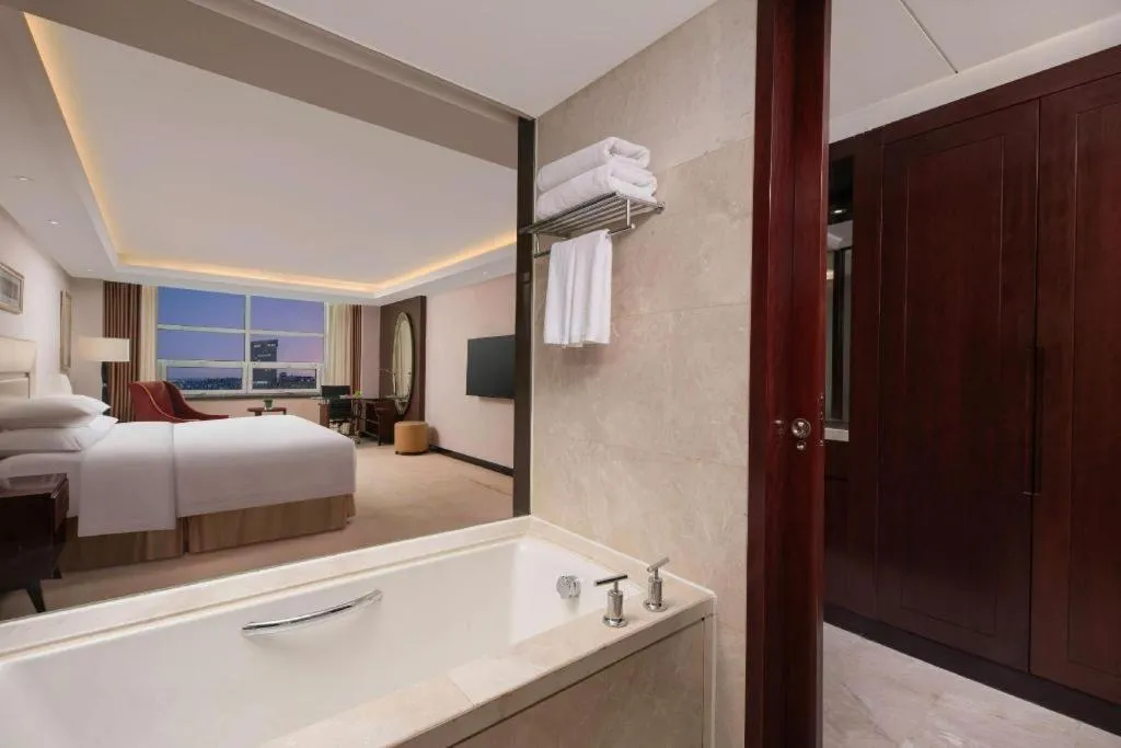 Bed in New Century Grand Changchun Hotel