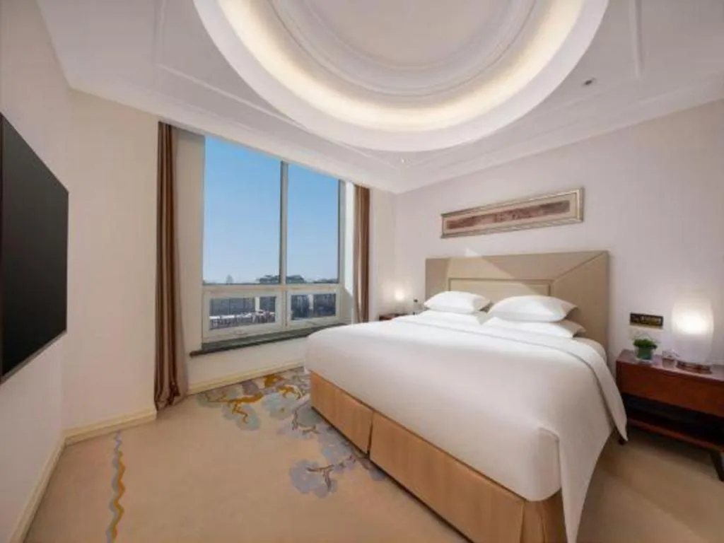 Bed in New Century Grand Changchun Hotel