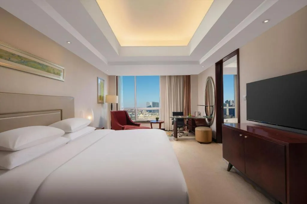 Bed in New Century Grand Changchun Hotel